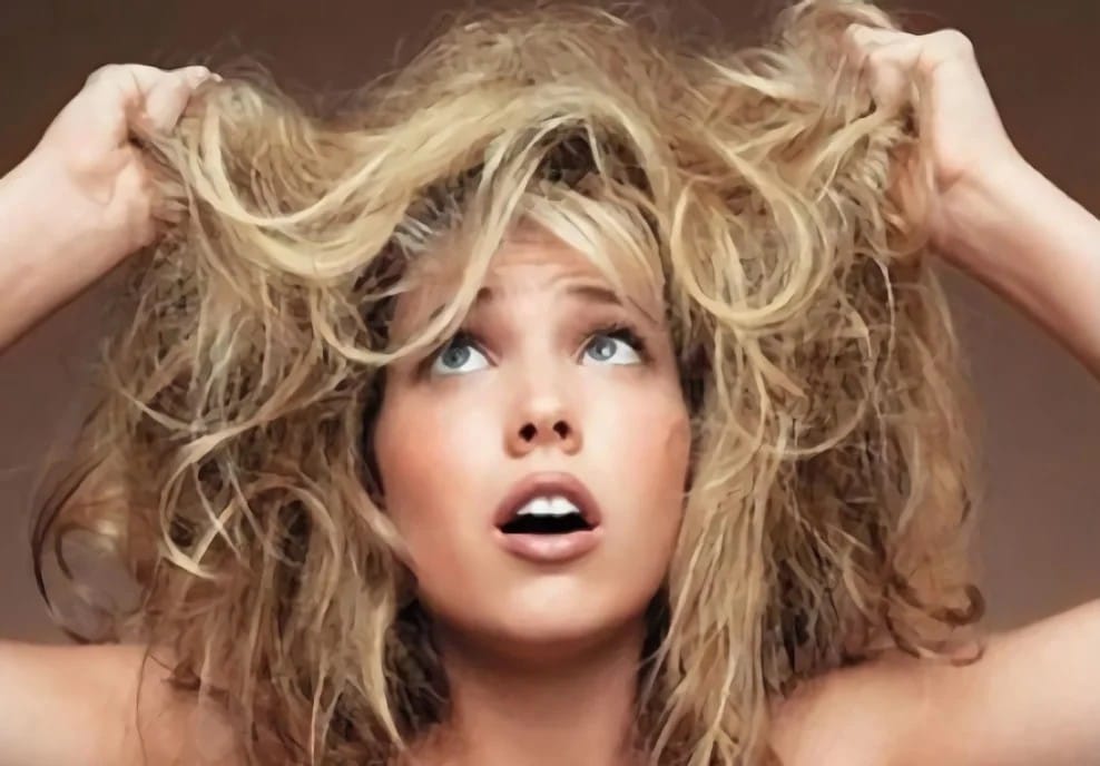 Woman frustrated with dry and damaged hair showing need for proper dry and damaged hair care routine