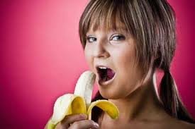 woman eating half banana healthy low calorie snack