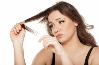Woman checking damaged strands while learning how to take care of dry hair naturally